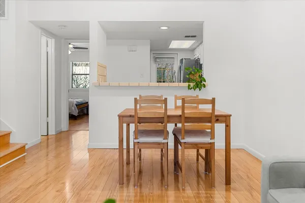 a view of a dining room with furniture and wooden floor