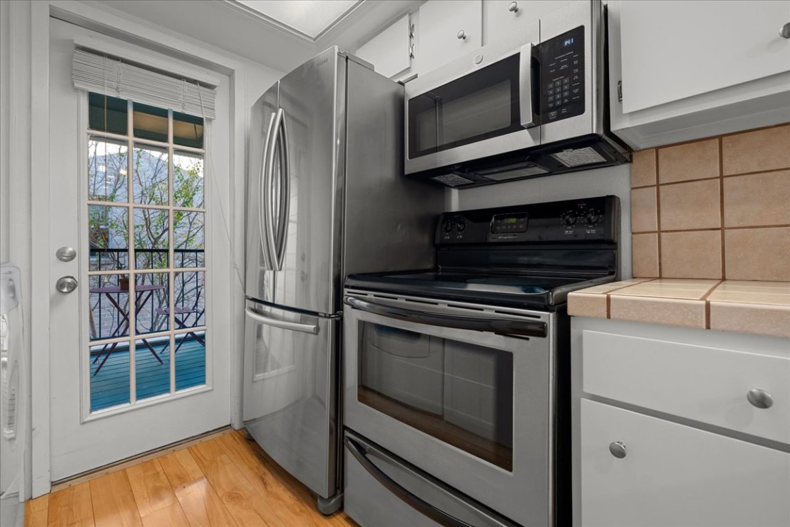 2104 Cullen Avenue, Unit 7204 Austin, TX 78757 - Photo 10 of 40 Refrigerator conveys with purchase. See the second balcony off of the kitchen.