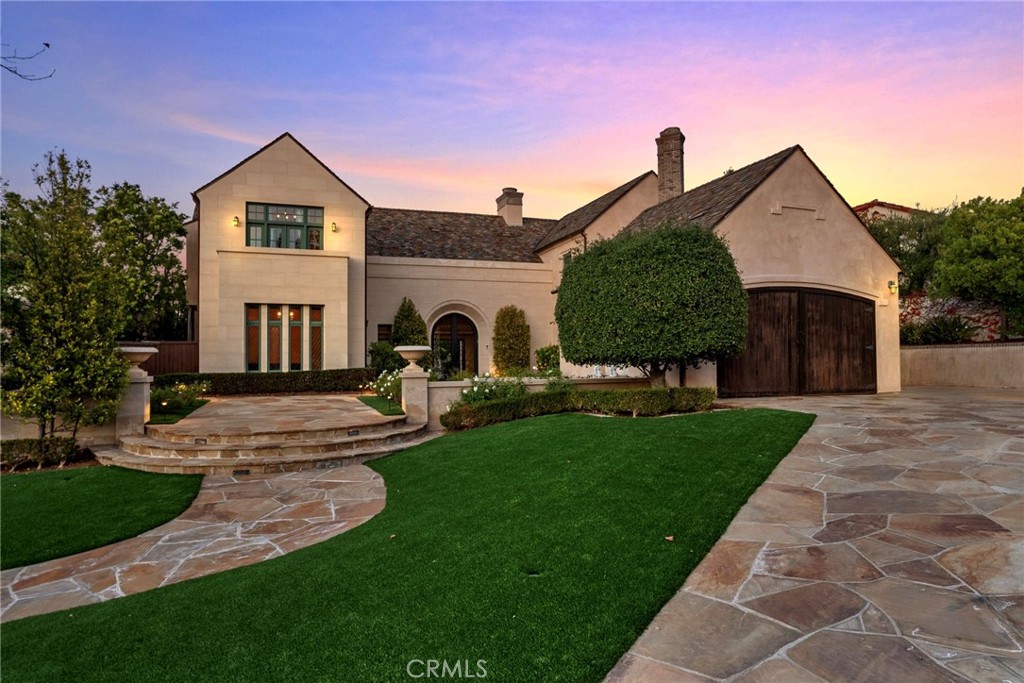 a front view of a house with yard and green space