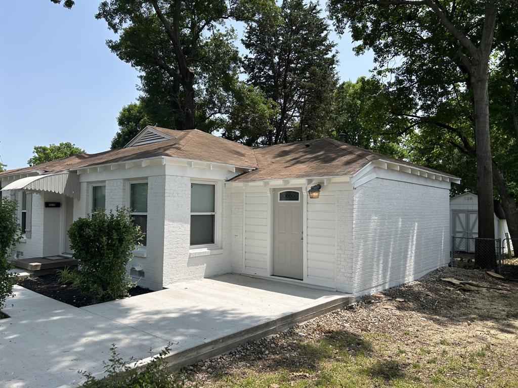 6318 Belgrade Avenue Dallas, TX 75227 - Photo 2 of 23 a view of a white house with a large tree and wooden fence
