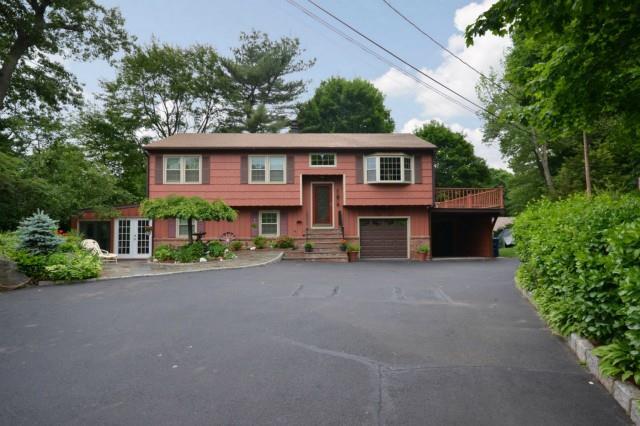73 Holland Road Bridgeport, CT 06610 - Photo 1 of 1 a red brick house with trees in front of it
