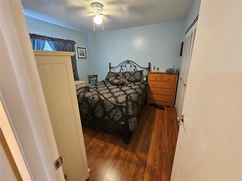 6650 Royal Palm Boulevard, Unit 315C Margate, FL 33063 - Photo 11 of 17 a bedroom with a bed and a mirror