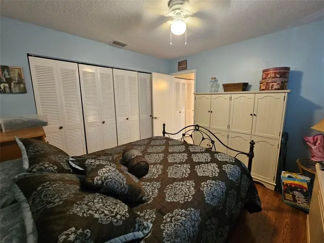 a bedroom with furniture and a wooden floor