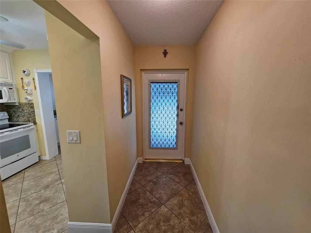 6650 Royal Palm Boulevard, Unit 315C Margate, FL 33063 - Photo 3 of 17 a view of a hallway with wooden floor and a living room