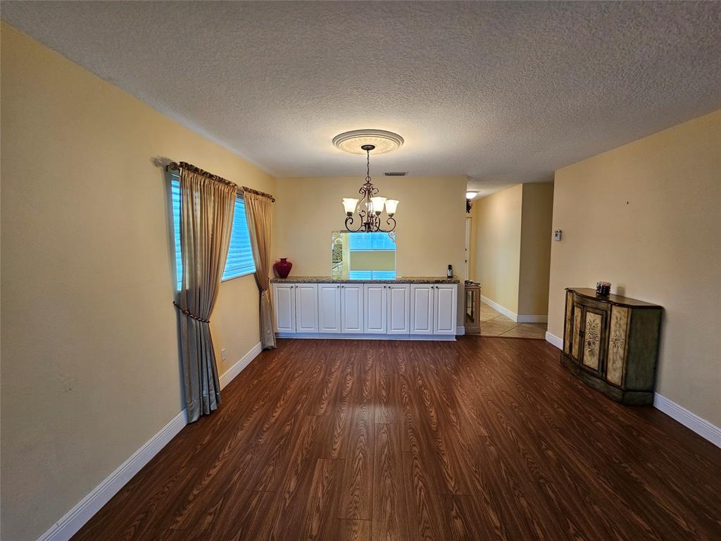 6650 Royal Palm Boulevard, Unit 315C Margate, FL 33063 - Photo 8 of 17 a living room with furniture and a wooden floor