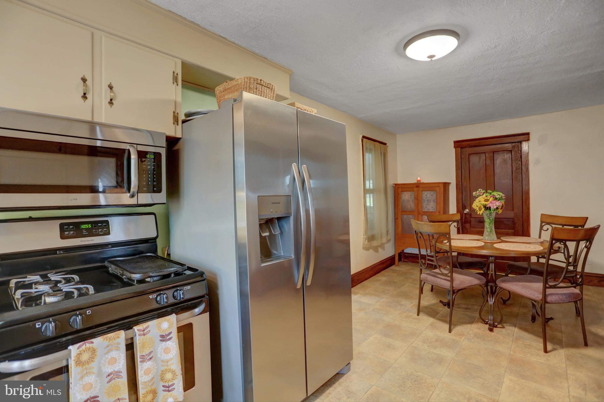 227 South Main Street Boonsboro, MD 21713 - Photo 21 of 53 a kitchen with stainless steel appliances granite countertop a stove refrigerator and a refrigerator