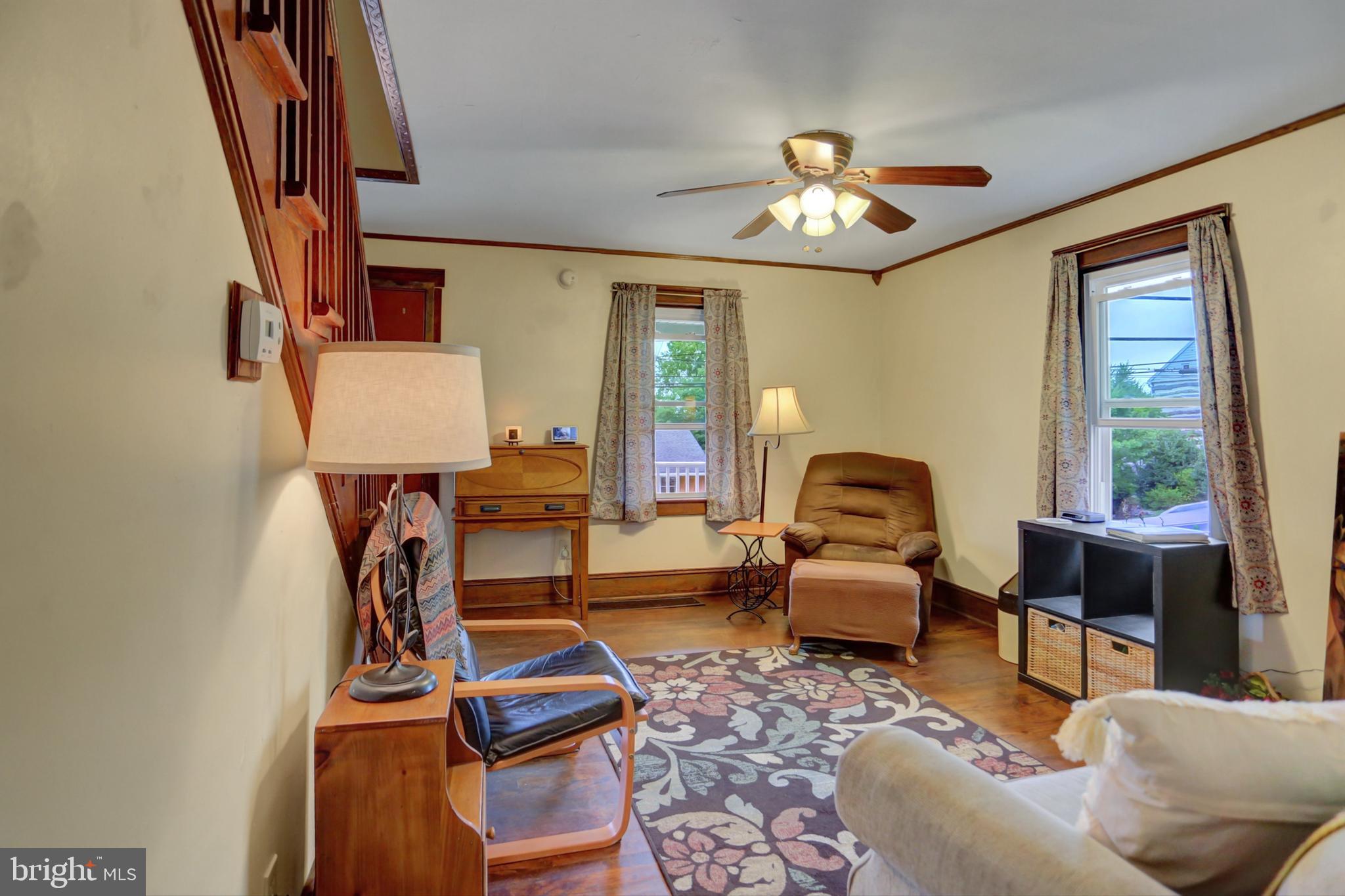 227 South Main Street Boonsboro, MD 21713 - Photo 9 of 53 a living room with furniture a chandelier and a flat screen tv