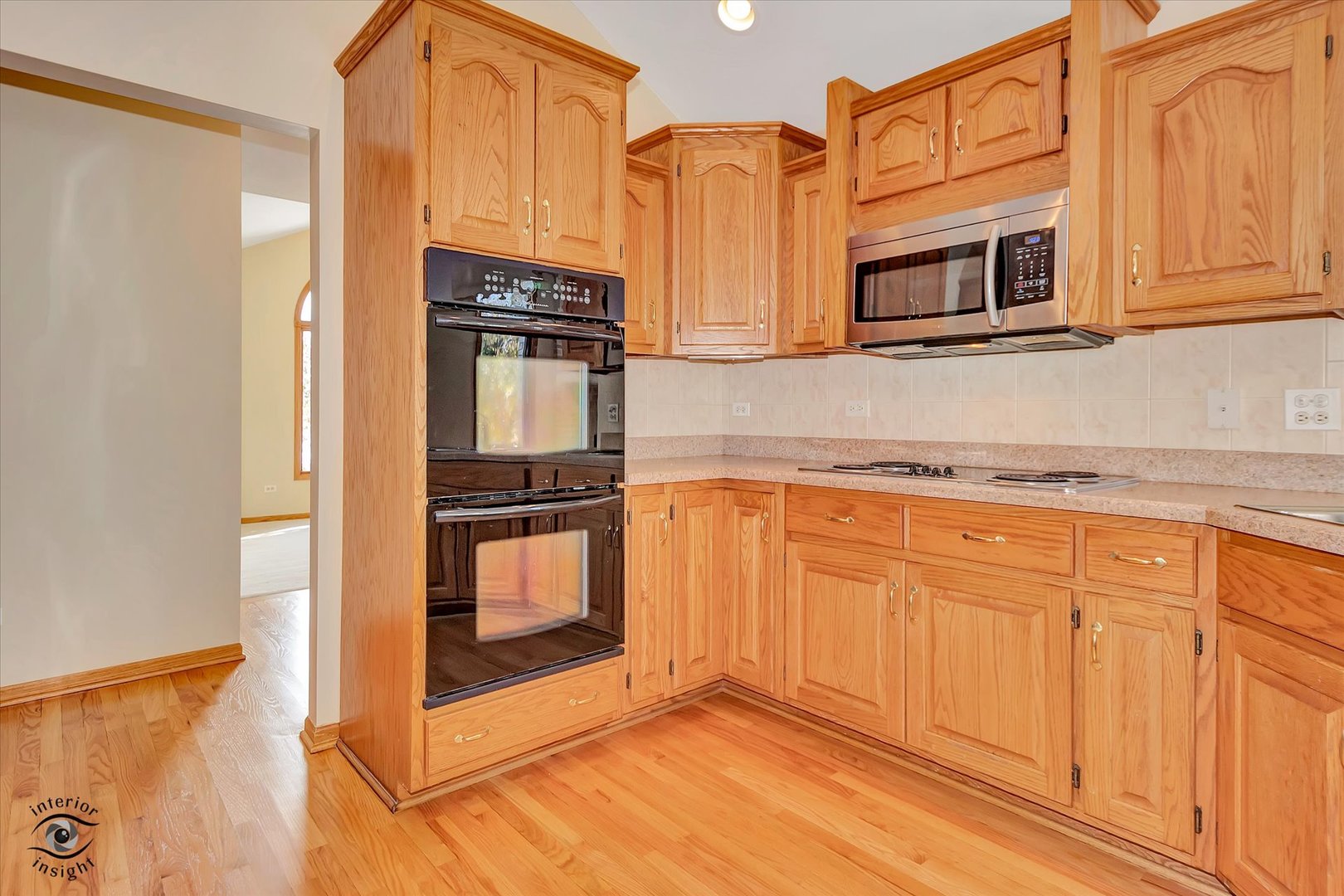 19612 Waterford Lane Mokena, IL 60448 - Photo 12 of 28 a kitchen with stainless steel appliances granite countertop a stove a microwave and a sink
