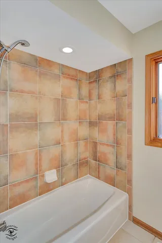a bathroom with a bathtub and shower