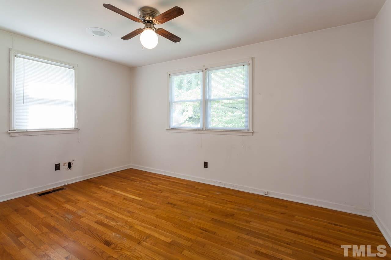 2252 Rumson Road Raleigh, NC 27610 - Photo 11 of 20 a view of empty room with wooden floor and fan