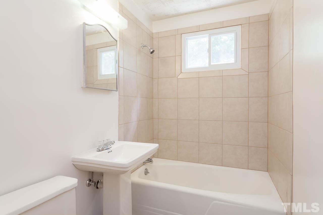 2252 Rumson Road Raleigh, NC 27610 - Photo 13 of 20 a bathroom with a sink bathtub and toilet
