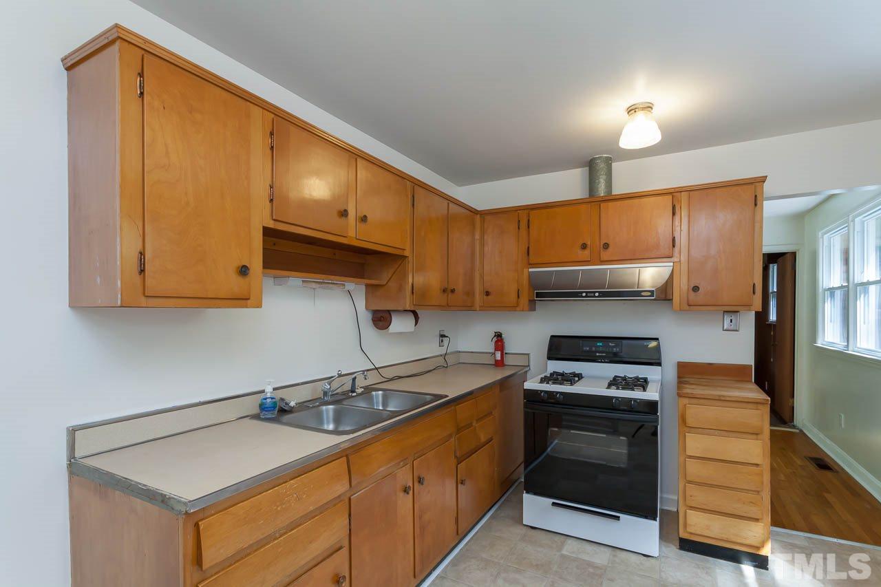 2252 Rumson Road Raleigh, NC 27610 - Photo 4 of 20 a kitchen with stainless steel appliances granite countertop a sink stove and refrigerator