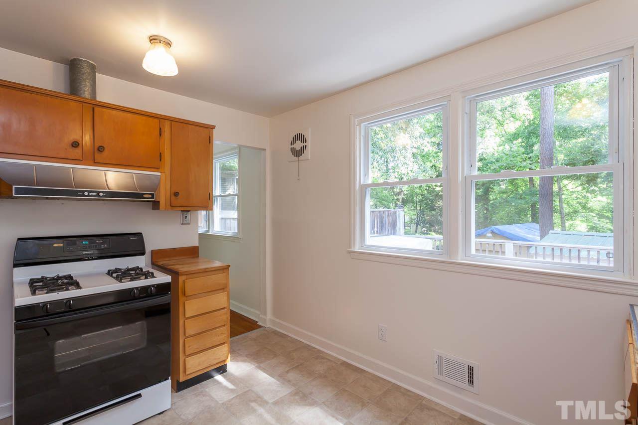 2252 Rumson Road Raleigh, NC 27610 - Photo 6 of 20 a kitchen with a stove and a microwave