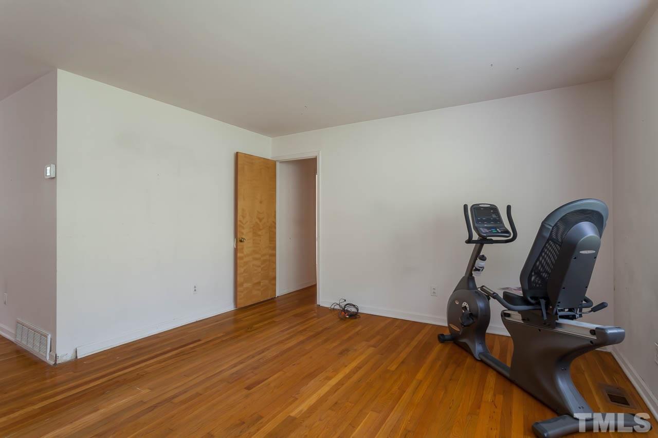 2252 Rumson Road Raleigh, NC 27610 - Photo 8 of 20 a bedroom with bed and wooden floor