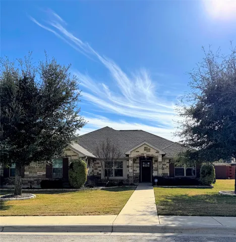 a view of a house with swimming pool and a yard