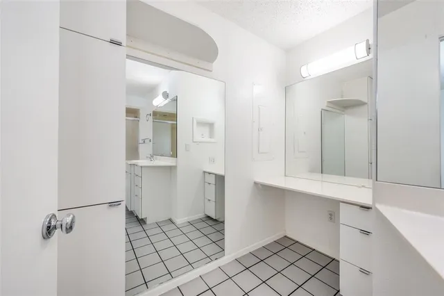a bathroom with a sink mirror and toilet
