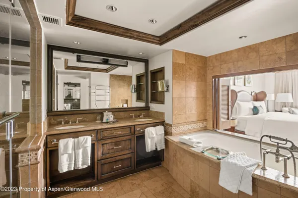 a living room with stainless steel appliances granite countertop furniture and a large window