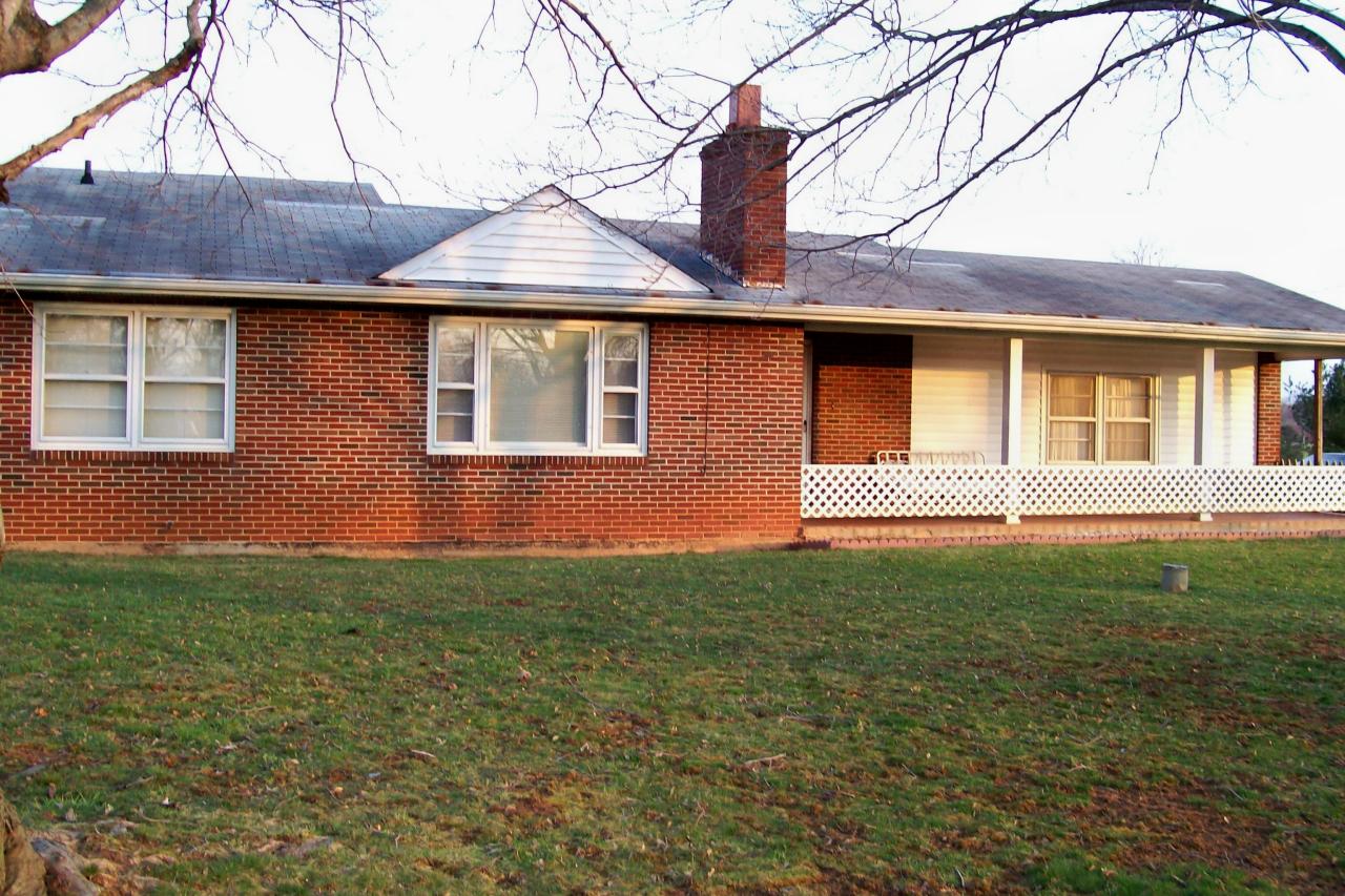 1494 Mill Iron Road Goodview, VA 24095 - Photo 1 of 10 a front view of a house with a yard and garage