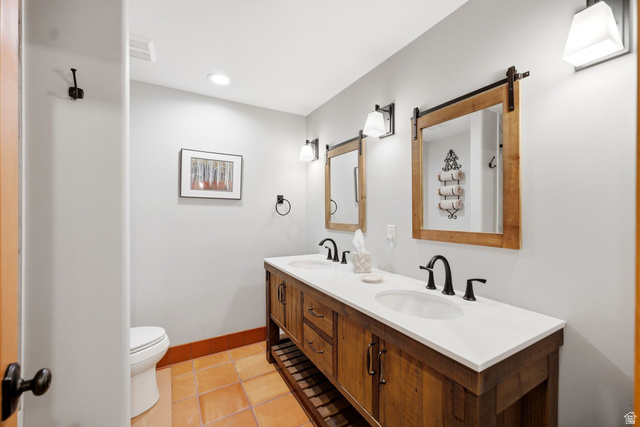 12465 Bone Road Kamas, UT 84036 - Photo 47 of 63 Dual vanity with wood-finish cabinetry, white countertop, and integrated sinks