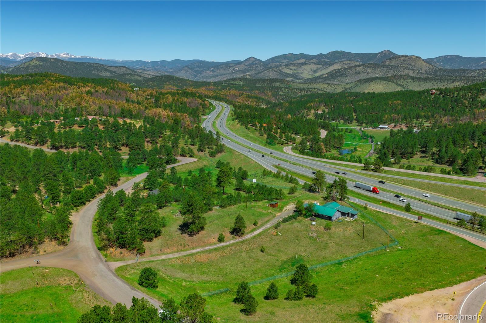 29793 Ruby Ranch Road Evergreen, CO 80439 - Photo 16 of 28 a view of a lush green hillside and a houses