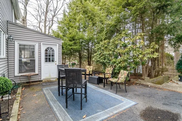 a view of a patio with table and chairs and potted plants