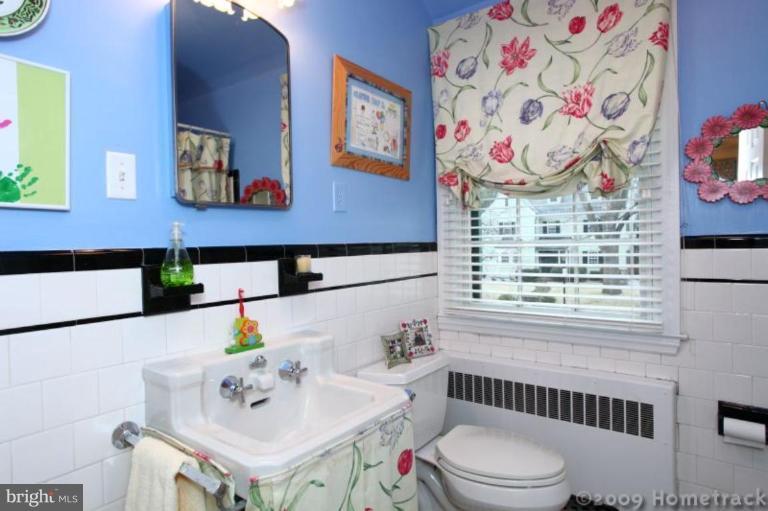 105 Enfield Road Baltimore, MD 21212 - Photo 14 of 28 a bathroom with a sink and a toilet