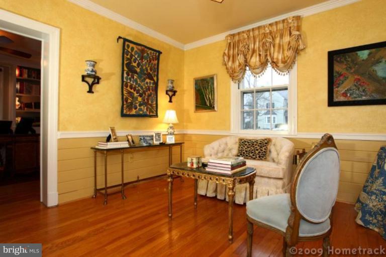 105 Enfield Road Baltimore, MD 21212 - Photo 8 of 28 a living room with furniture and painting on the wall next to a window