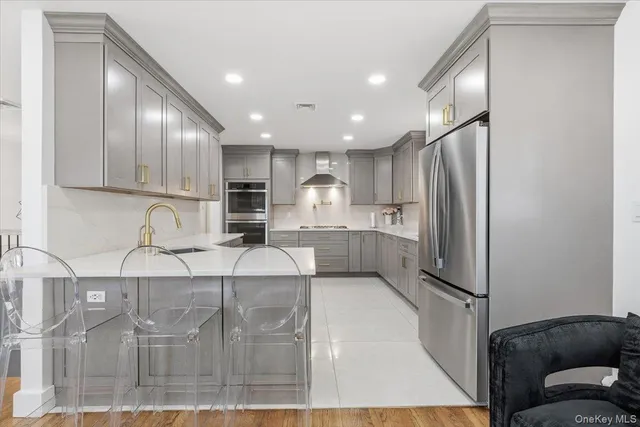 a kitchen with kitchen island granite countertop stainless steel appliances and cabinets