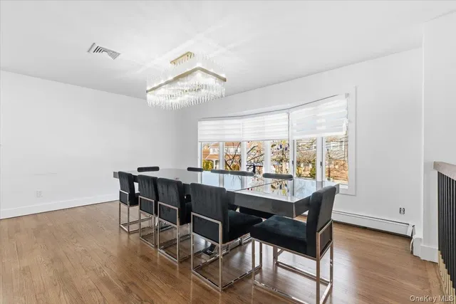 a view of a dining room and hall with wooden floor