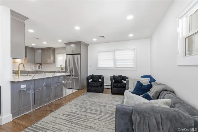 a living room with furniture and kitchen view