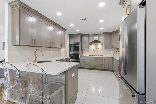 a kitchen with stainless steel appliances granite countertop a refrigerator and a sink