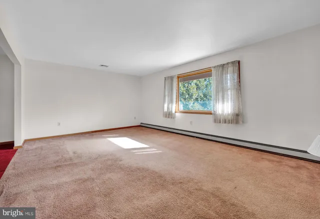 an empty room with windows and entrance