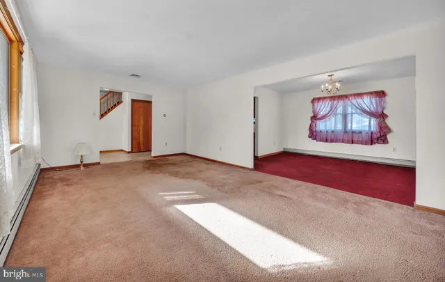 a view of a room with wooden floor