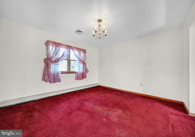 a view of a kitchen with a sink refrigerator and a window