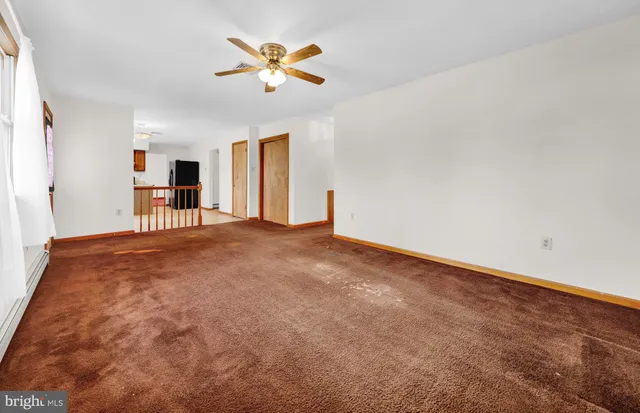 an empty room with a empty space and a ceiling fan