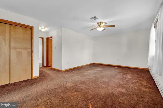 a view of a livingroom with a ceiling fan and window