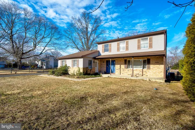 a view of a hallway with wooden floor and entryway