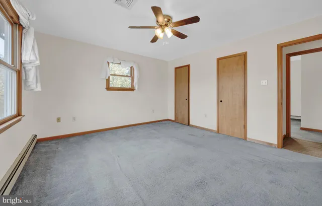 a backyard of a house with large trees