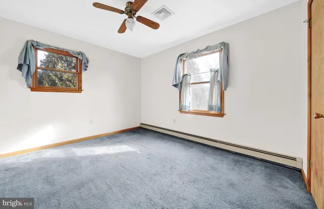 a view of a house with backyard and trees