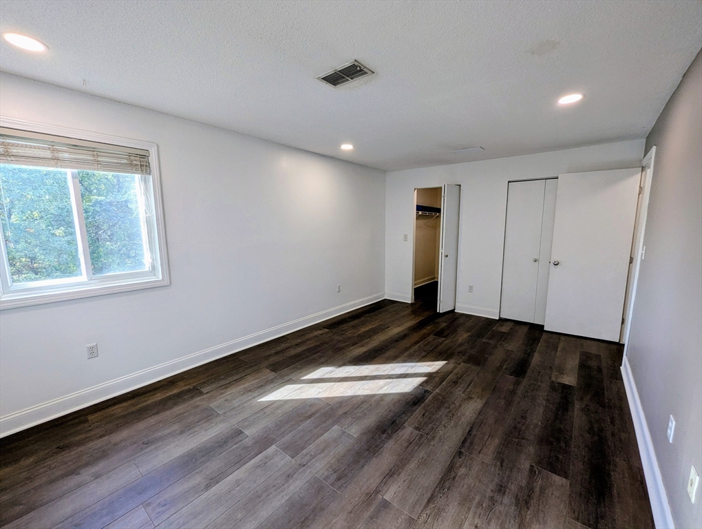 809 Franklin Crossing Road, Unit 809 Franklin, MA 02038 - Photo 11 of 15 a view of a room with wooden floor and window