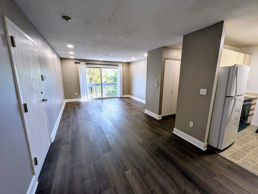 809 Franklin Crossing Road, Unit 809 Franklin, MA 02038 - Photo 2 of 15 an empty room with wooden floor and a window