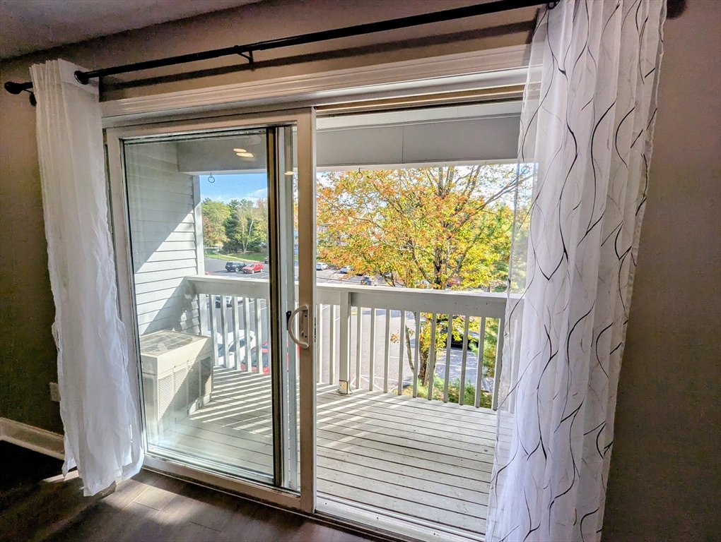 809 Franklin Crossing Road, Unit 809 Franklin, MA 02038 - Photo 4 of 15 a view of balcony and wooden floor