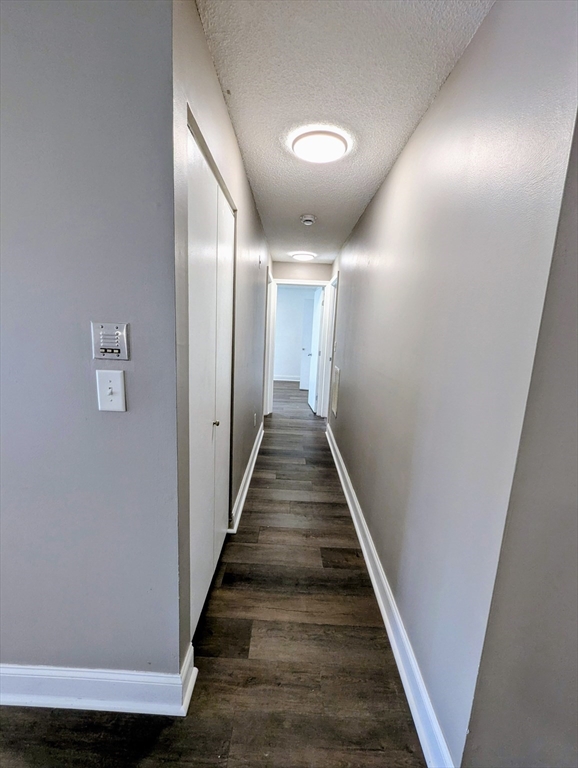 809 Franklin Crossing Road, Unit 809 Franklin, MA 02038 - Photo 7 of 15 a view of a hallway with wooden floor and staircase