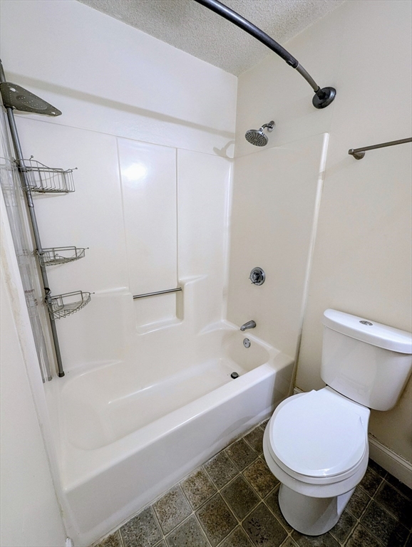 809 Franklin Crossing Road, Unit 809 Franklin, MA 02038 - Photo 9 of 15 a white bath tub sitting next to a white toilet and sink