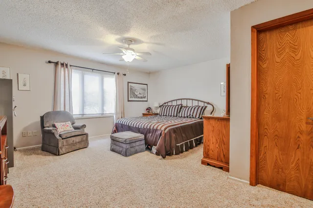 a bedroom with a bed couch and window