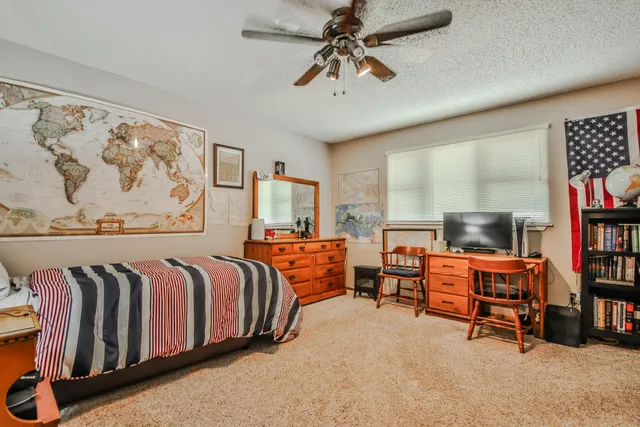 a bedroom with furniture and a book shelf