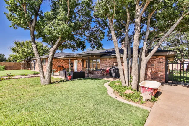 a view of a house with backyard porch and sitting area