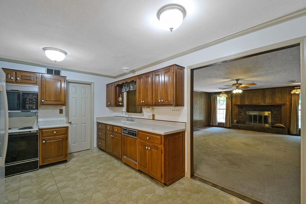 1514 Ivy Road Memphis, TN 38117 - Photo 12 of 30 a kitchen with stainless steel appliances granite countertop a stove and a sink