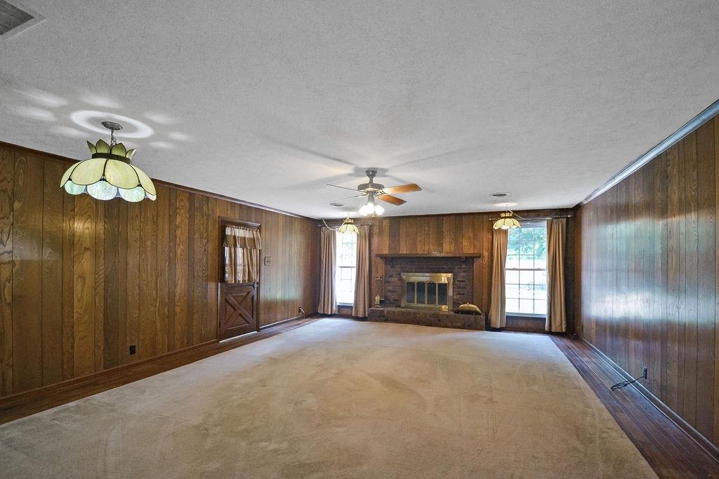 1514 Ivy Road Memphis, TN 38117 - Photo 14 of 30 a view of a livingroom with a fireplace cabinet and windows