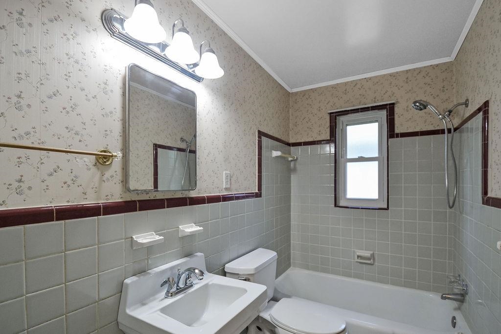 1514 Ivy Road Memphis, TN 38117 - Photo 19 of 30 a bathroom with a sink a toilet and mirror